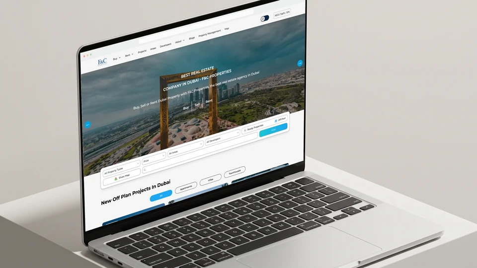 F and C Properties’ Dubai property website displayed on a silver laptop
